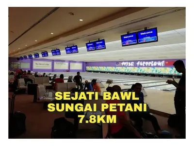 a group of people sitting in an airport with a bowling alley at Ulie Empire Homestay in Sungai Petani