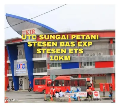 a building with a sign in front of it at Ulie Empire Homestay in Sungai Petani