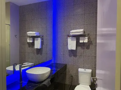 a bathroom with a white toilet and a sink at Hotel Warisan in Taiping