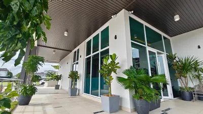 a building with potted plants in front of it at Hotel Warisan in Taiping