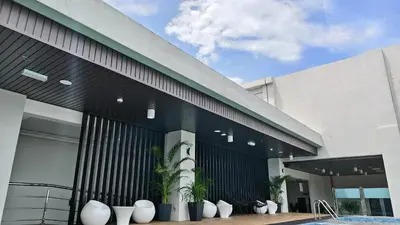 a building with potted plants in front of it at Hotel Warisan in Taiping