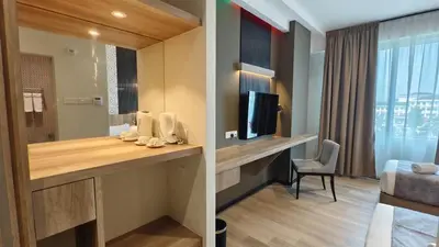 a hotel room with a desk and a television at Hotel Warisan in Taiping