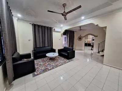a living room with black furniture and a table at LB Homestay in Lunas