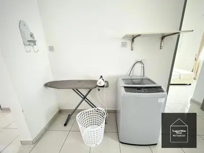 a small kitchen with a table and a trash can at Homestay Meru Ipoh Mus Lim Only Tropical White House in Ipoh