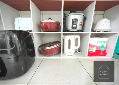a kitchen shelf with pots and pans and a appliance at Homestay Meru Ipoh Mus Lim Only Tropical White House in Ipoh