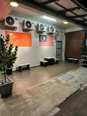 a room with speakers on the wall and an american flag at LM Homestay in Kulim