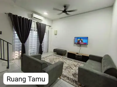 a living room with a couch and a tv at Homestay AinulZahra- For Malays Only in Seri Iskandar