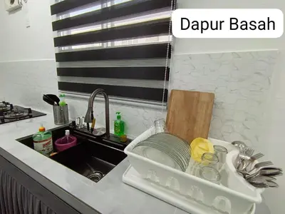 a kitchen sink with a dish drying rack in it at Homestay AinulZahra- For Malays Only in Seri Iskandar