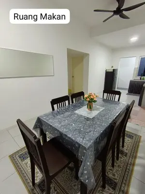 a dining room with a table with chairs and a tableablish at Homestay AinulZahra- For Malays Only in Seri Iskandar