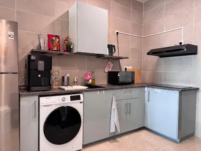 a kitchen with a dishwasher and a washer at ICC Suites Ipoh City Centre Walking Distance to Shopping Mall in Ipoh