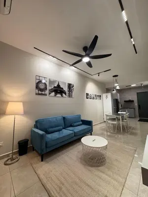 a living room with a blue couch and a ceiling fan at ICC Suites Ipoh City Centre Walking Distance to Shopping Mall in Ipoh
