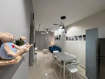 a kitchen and dining room with a teddy bear on a counter at ICC Suites Ipoh City Centre Walking Distance to Shopping Mall in Ipoh