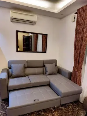 a living room with a couch and a mirror at fz north silibin in Ipoh
