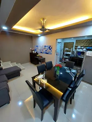 a dining room and living room with a table and chairs at fz north silibin in Ipoh