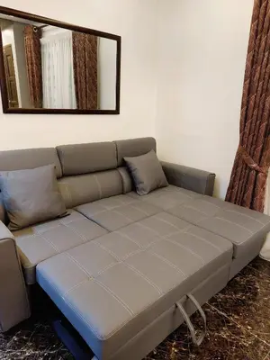 a couch in a living room with a mirror at fz north silibin in Ipoh