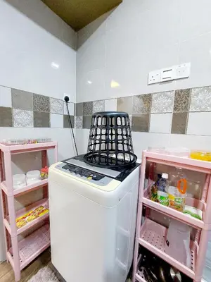 a white refrigerator with a stove top in a kitchen at fz north silibin in Ipoh