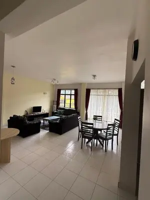 a living room with a table and chairs at Cameron Prima Villa Homestay in Tanah Rata