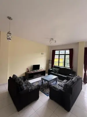a living room with two couches and a coffee table at Cameron Prima Villa Homestay in Tanah Rata