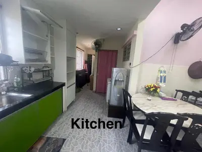 a kitchen with a table and a sink and a refrigerator at ZzHomestay