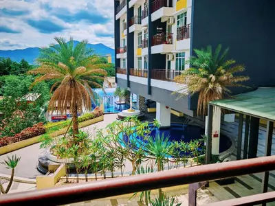 an apartment building with palm trees and a swimming pool at Ipoh Majestic Modern City 2BR Condo - Food Street in Ipoh