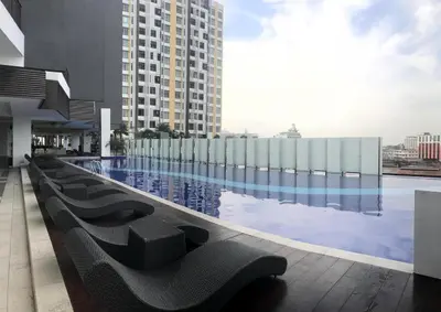 a large swimming pool with chairs and a building at Ipoh Majestic Modern City 2BR Condo - Food Street in Ipoh