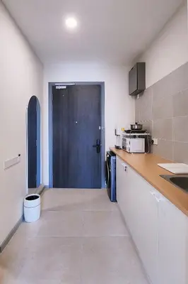a kitchen with a black door and a counter top at SkyPool at 22Macalisterz - Georgetown City Centre, 4pax by PG Home in George Town
