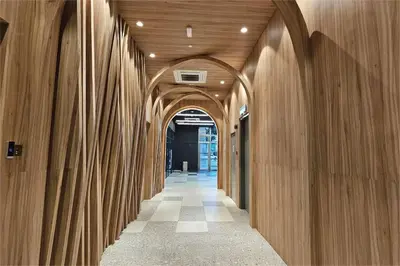 a hallway with wooden walls and an archway at SkyPool at 22Macalisterz - Georgetown City Centre, 4pax by PG Home in George Town