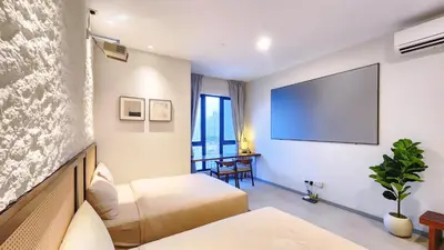 a hotel room with two beds and a flat screen tv at SkyPool at 22Macalisterz - Georgetown City Centre, 4pax by PG Home in George Town