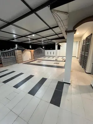 a large empty room with ailed floor in a building at KMK Homestay in Sungai Petani