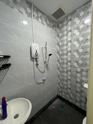 a bathroom with a sink and a shower in it at KMK Homestay in Sungai Petani