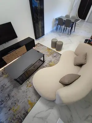 a living room with a white couch and a table at Tranquility Grove The Italian Modern Condo in Ipoh in Ipoh