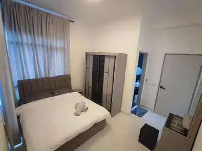 a small bedroom with a bed with a mirror at Tranquility Grove The Italian Modern Condo in Ipoh in Ipoh