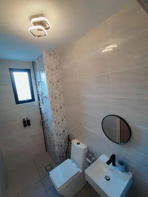 a bathroom with a toilet and a sink and a mirror at Tranquility Grove The Italian Modern Condo in Ipoh in Ipoh