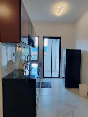 a kitchen with black cabinets and a counter top at Tranquility Grove The Italian Modern Condo in Ipoh in Ipoh