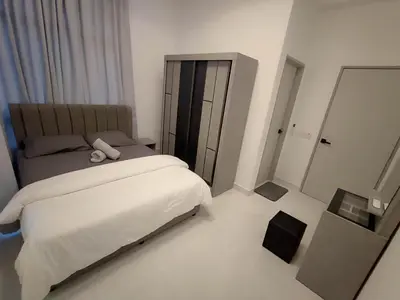 a bedroom with a large bed and a mirror at Tranquility Grove The Italian Modern Condo in Ipoh in Ipoh