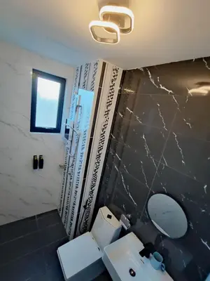 a bathroom with a white toilet and a sink at Tranquility Grove The Italian Modern Condo in Ipoh in Ipoh
