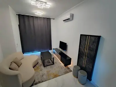 a living room with a couch and a television at Tranquility Grove The Italian Modern Condo in Ipoh in Ipoh