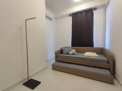 a bed in a room with a black curtain at Tranquility Grove The Italian Modern Condo in Ipoh in Ipoh