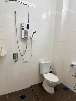 a bathroom with a toilet and a shower at MU Homestay in Simpang Ampat