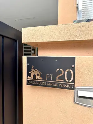 a sign on the side of a building that reads pt monitoring built warranty permit at MU Homestay in Simpang Ampat