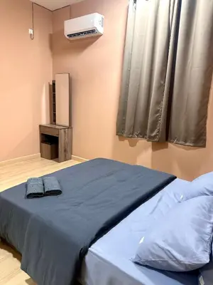 a bedroom with a bed and a air conditioner at MU Homestay in Simpang Ampat