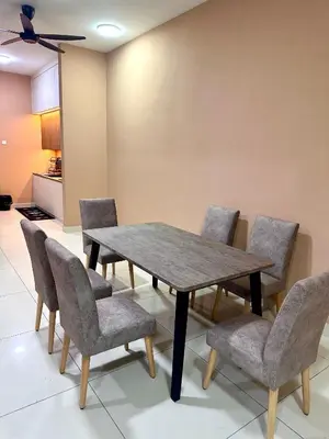 a dining room table with chairs and a table and a ceiling at MU Homestay in Simpang Ampat