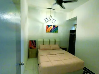 a bed in a room with a ceiling fan at HomeStay Amer in Ipoh