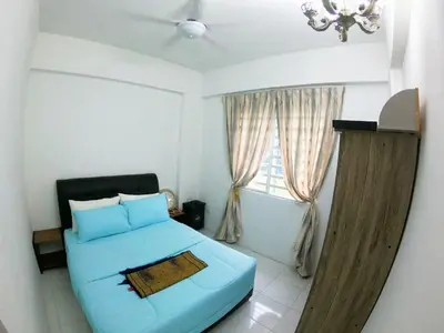 a bedroom with a blue bed and a window at HomeStay Amer in Ipoh