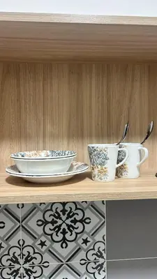a wooden shelf with two cups and plates on it at StudioMimi Near UTP UiTM Seri Iskandar in Seri Iskandar