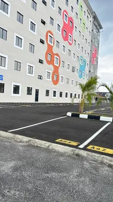 an empty parking lot in front of a building at StudioMimi Near UTP UiTM Seri Iskandar in Seri Iskandar