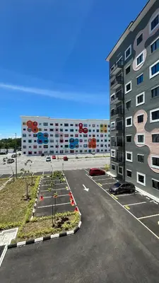 a parking lot in front of a large building at StudioMimi Near UTP UiTM Seri Iskandar in Seri Iskandar