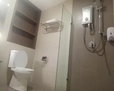 a bathroom with a toilet and a glass shower stall at U Design Hotel Bukit Mertajam in Bukit Mertajam