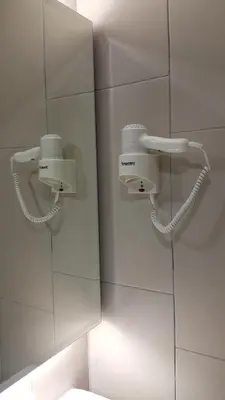 a bathroom with two lights on the wall at U Design Hotel Bukit Mertajam in Bukit Mertajam