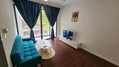 a living room with a blue couch and a tv at CAMERON HIGHLAND BRINCHANG KEA FARM Homestay By Dcozy 6-7pax in Brinchang